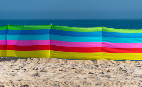 Beach screen on the polish beach on a sunny summer day in the background beautiful sea.