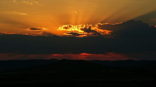 Scenic view of mountains against cloudy sky