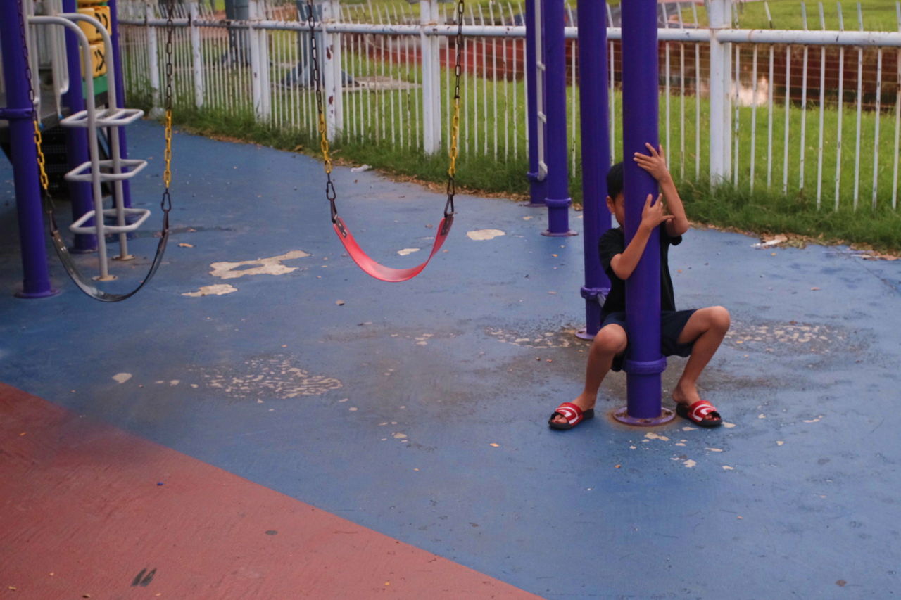 full length, child, childhood, real people, one person, lifestyles, girls, females, leisure activity, day, fun, women, casual clothing, playground, offspring, barefoot, enjoyment, boys, outdoor play equipment, innocence