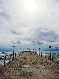 Pier over sea against sky