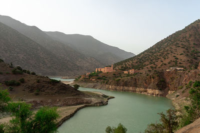 Scenic view of lake and mountains against clear sky