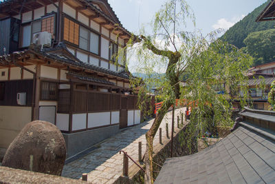 Houses by street in town against sky