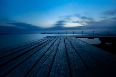 Pier over sea against blue sky