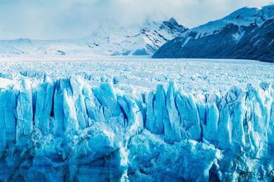 Scenic view of frozen lake against mountain range