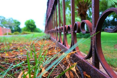 Close-up of rusty metallic structure against sky