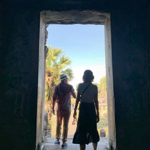 Rear view of couple at entrance of historic building