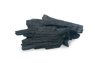 Close-up of stack of firewood against white background