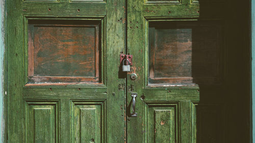 Closed wooden green antique door