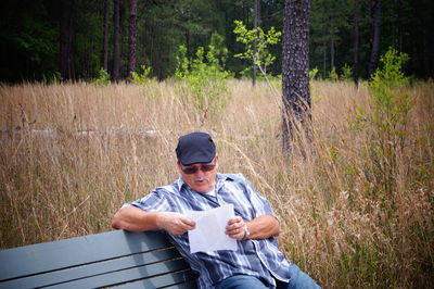 Full length of man sitting in forest