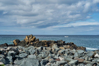 View to the ocean with boat and big sky.