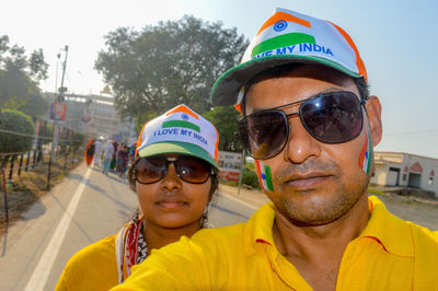 Portrait of couple with flag pattern painted face in city