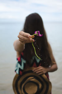 Woman holding wet flower