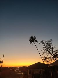 Silhouette palm trees against sky during sunset