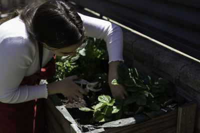 Young woman gardening at yard