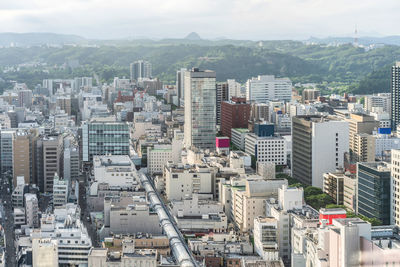 High angle view of buildings in city against sky