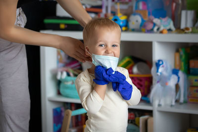 Portrait of cute boy standing at home