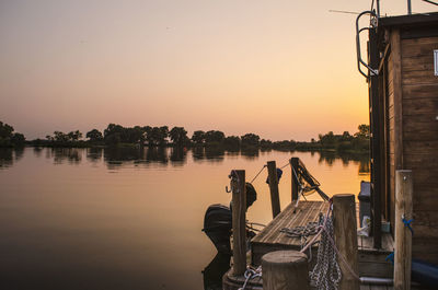 Boat moored on lake against sky