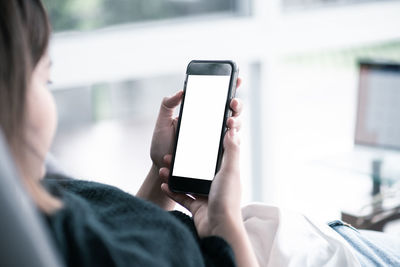 Midsection of man using mobile phone