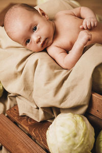 Portrait of cute baby boy sleeping on bed at home