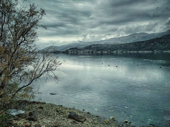 Scenic view of lake against sky during winter