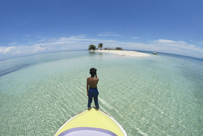 Rear view of boy on boat