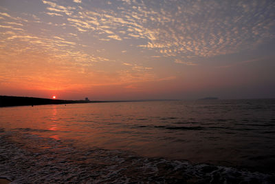 Scenic view of sea against romantic sky at sunset