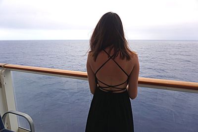 Rear view of woman standing on beach