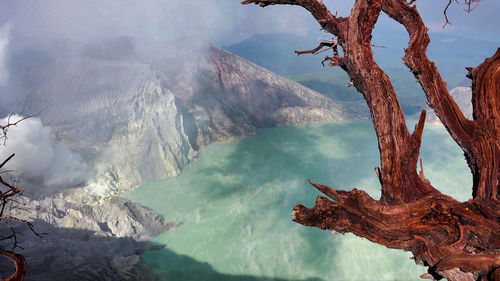 Scenic view of sea and mountains against sky