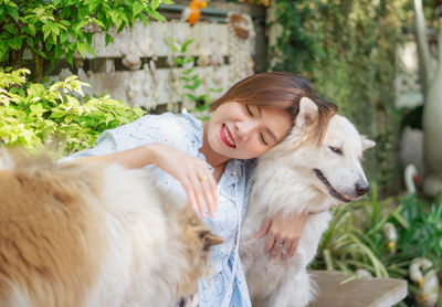 Smiling young woman with dogs in yard