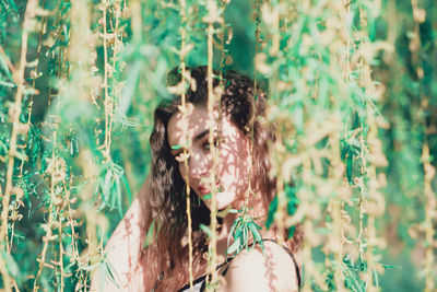 Young woman amidst plants