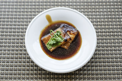 High angle view of braised pork in plate on table