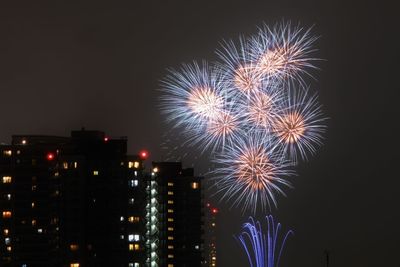 Low angle view of firework display at night