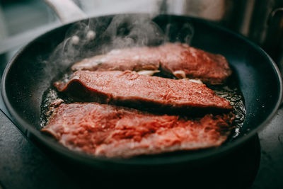 Close-up of meat in cooking pan