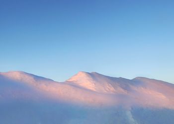 Scenic view of mountains against clear blue sky