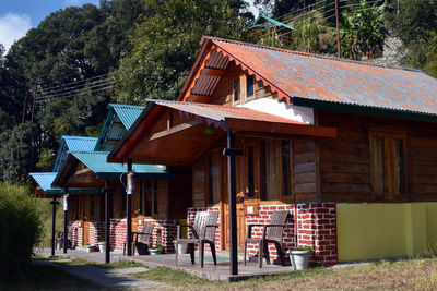 Row of barn on field against buildings