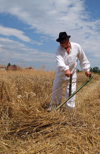 Man standing on field against sky