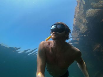 Low angle view of man swimming in sea