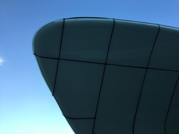 Low angle view of modern building against clear blue sky