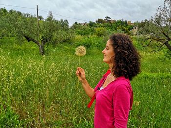 Girl with dandelion in the countryside