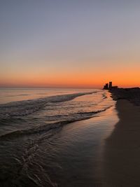 Scenic view of sea against clear sky during sunset