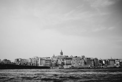 Boats in river with buildings in background