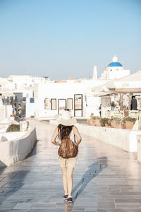 Woman standing in front of footpath