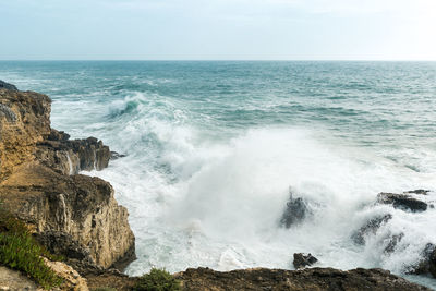 Coastline with atlantic ocean in cascais, portugal. waves at the shore and rocky hills