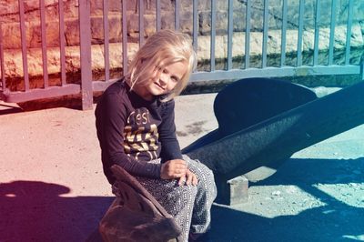 Portrait of girl sitting on anchor