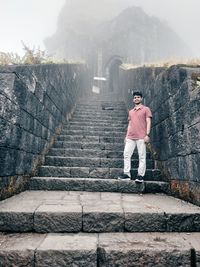 Rear view of man standing on staircase