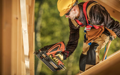 Side view of man working at construction site