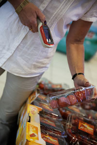 Senior woman using barcode reader