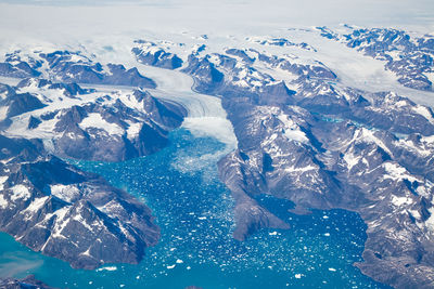 Aerial view of snowcapped mountains and sea