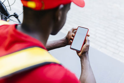 Delivery man using mobile phone