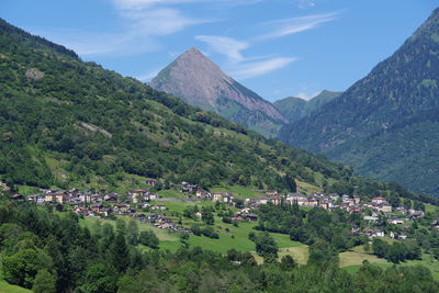 Panoramic view of townscape and mountains against sky